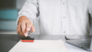 Vecteezy a young executive is stamping on documents for a business 10146450 2048x1152 1 300x169